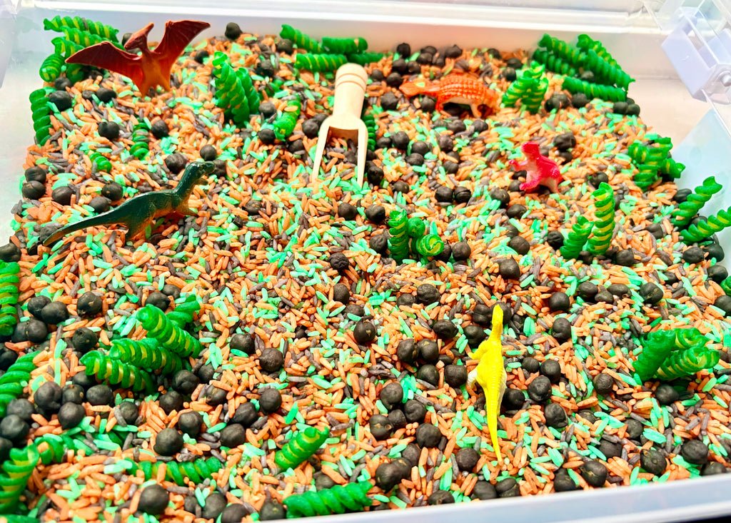 Close-up of colourful dinosaur-themed sensory filler and dinosaur play pieces